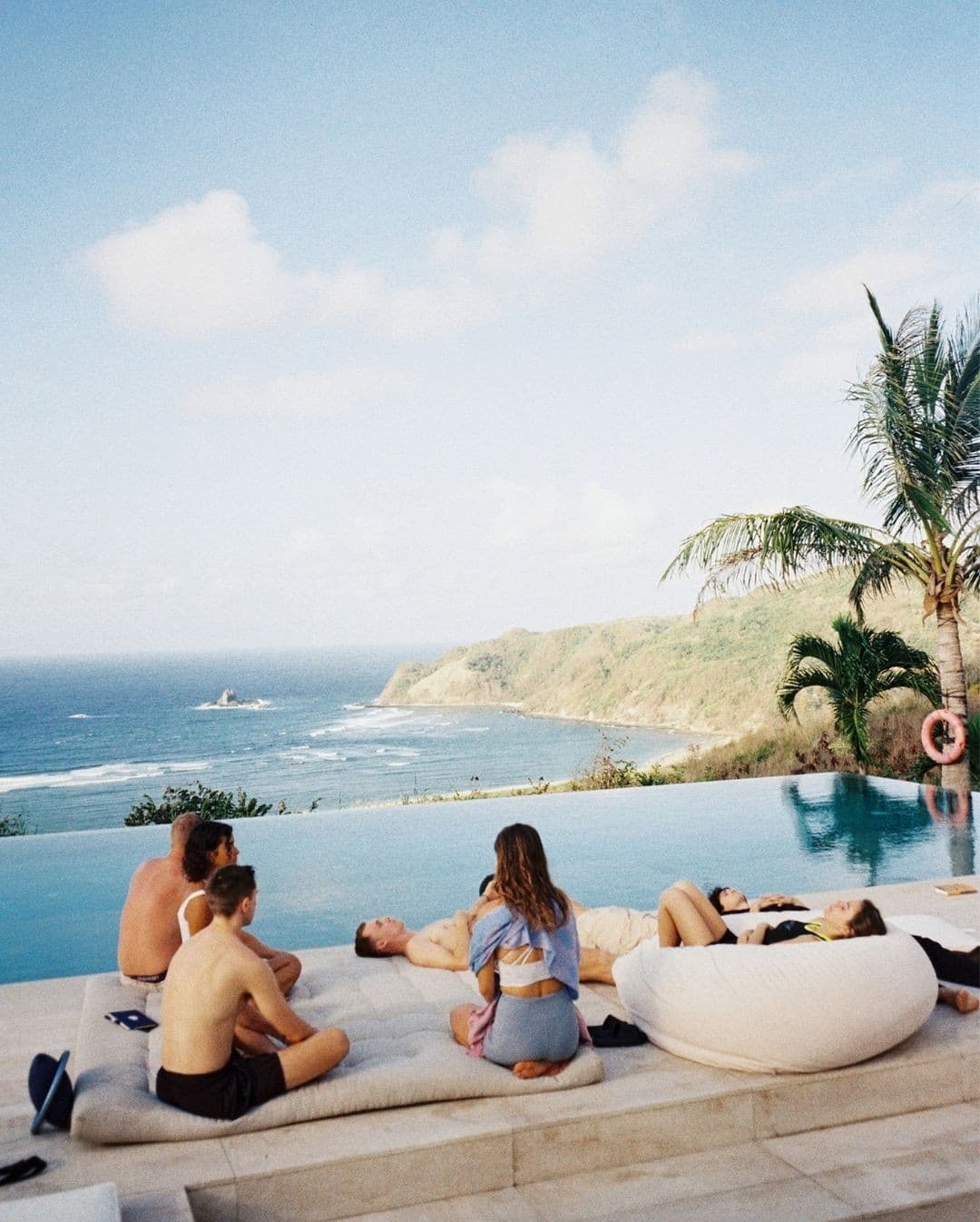 Relaxing by infinity pool with ocean views